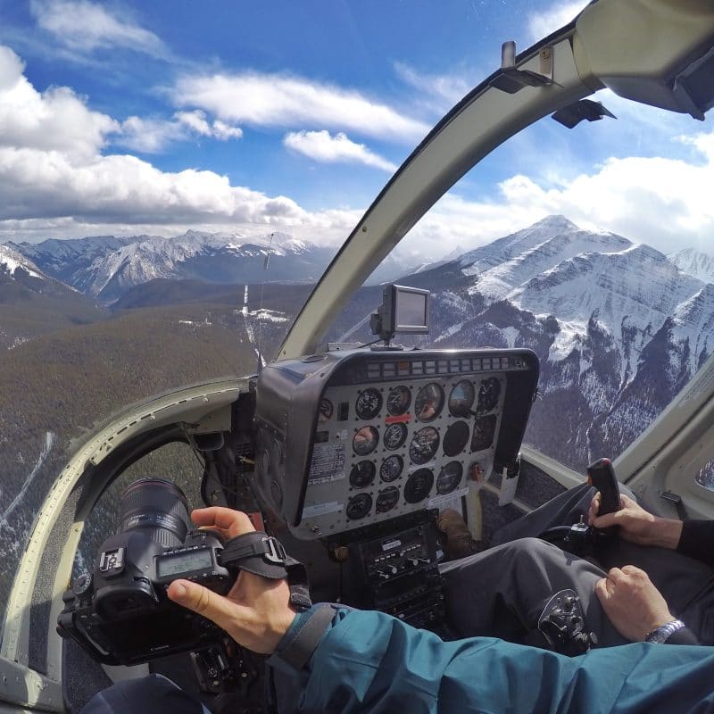 Using the Clutch to hold my camera in a helicopter where a shoulder strap is impractical for safety reasons.