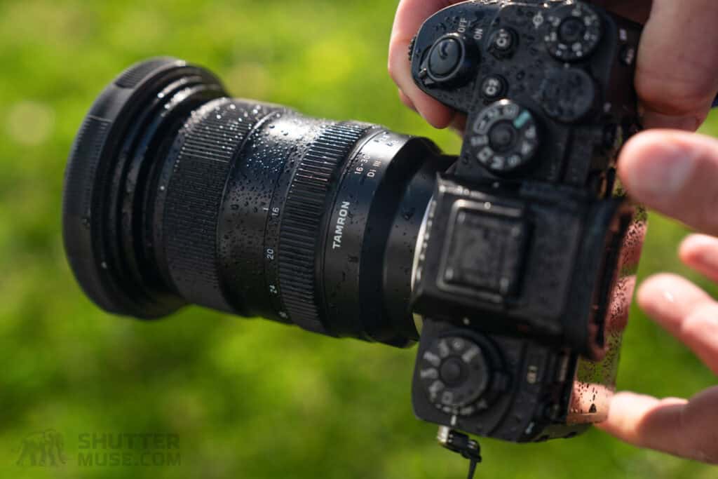 Tamron 16-30mm f/2.8 lens on a green background.
